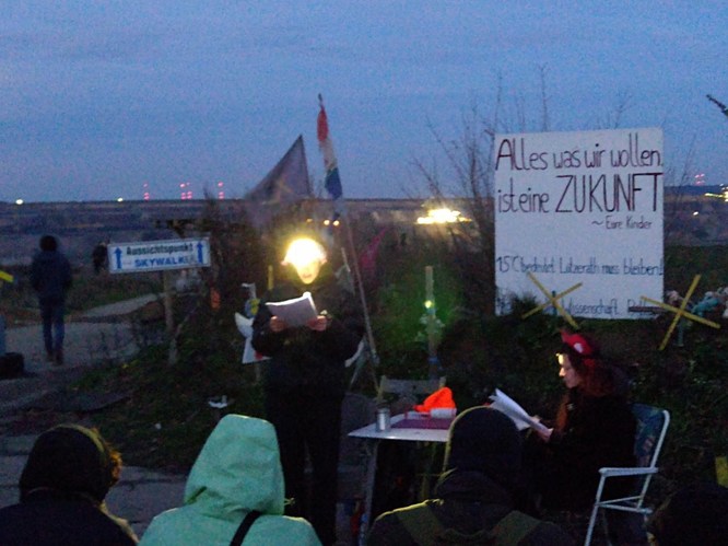 two people reading with headlamp in front of a lignite open pit mine